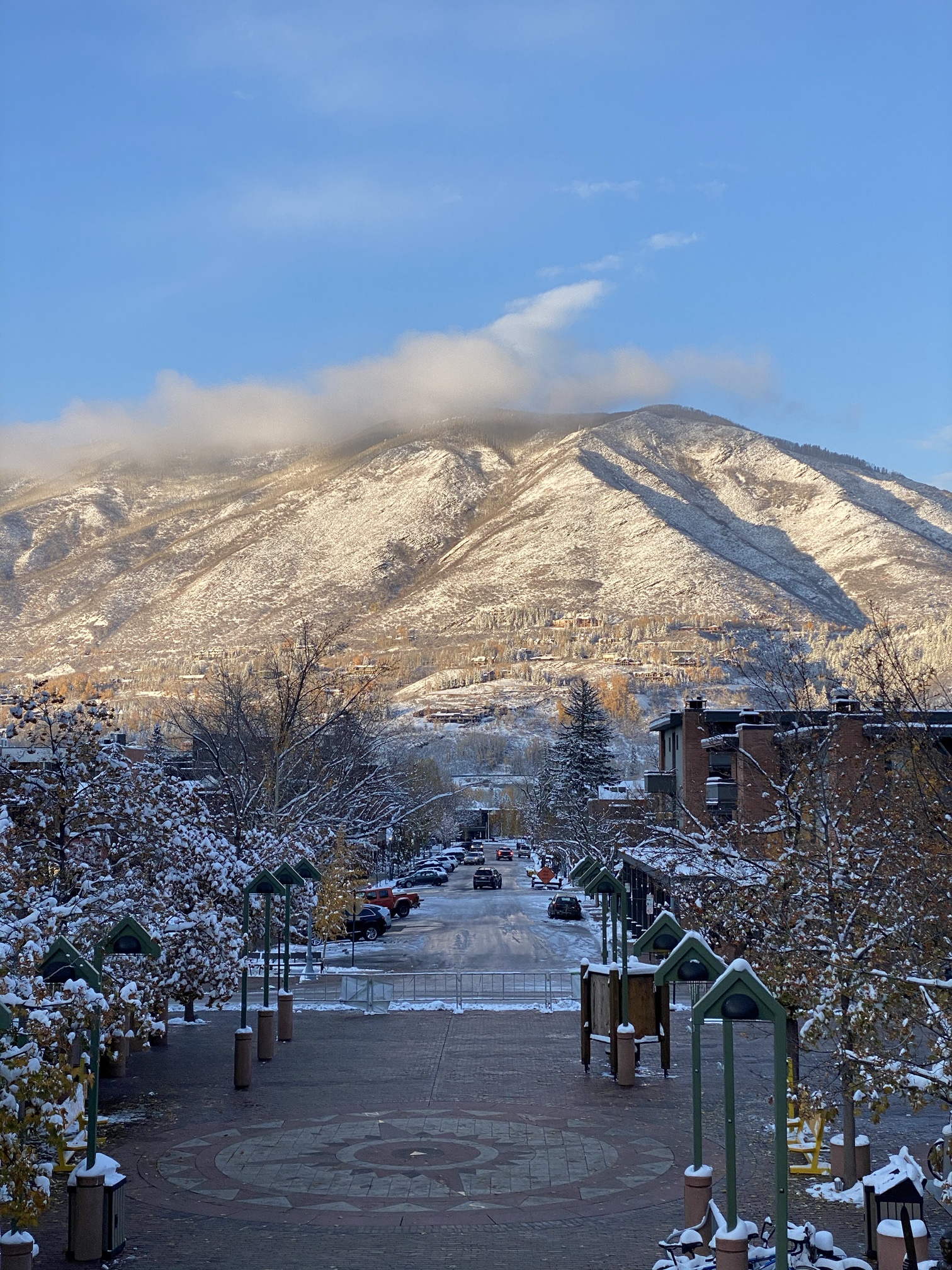 Fresh snow on the Aspen Mountain gondola plaza, looking across town to Red Mountain