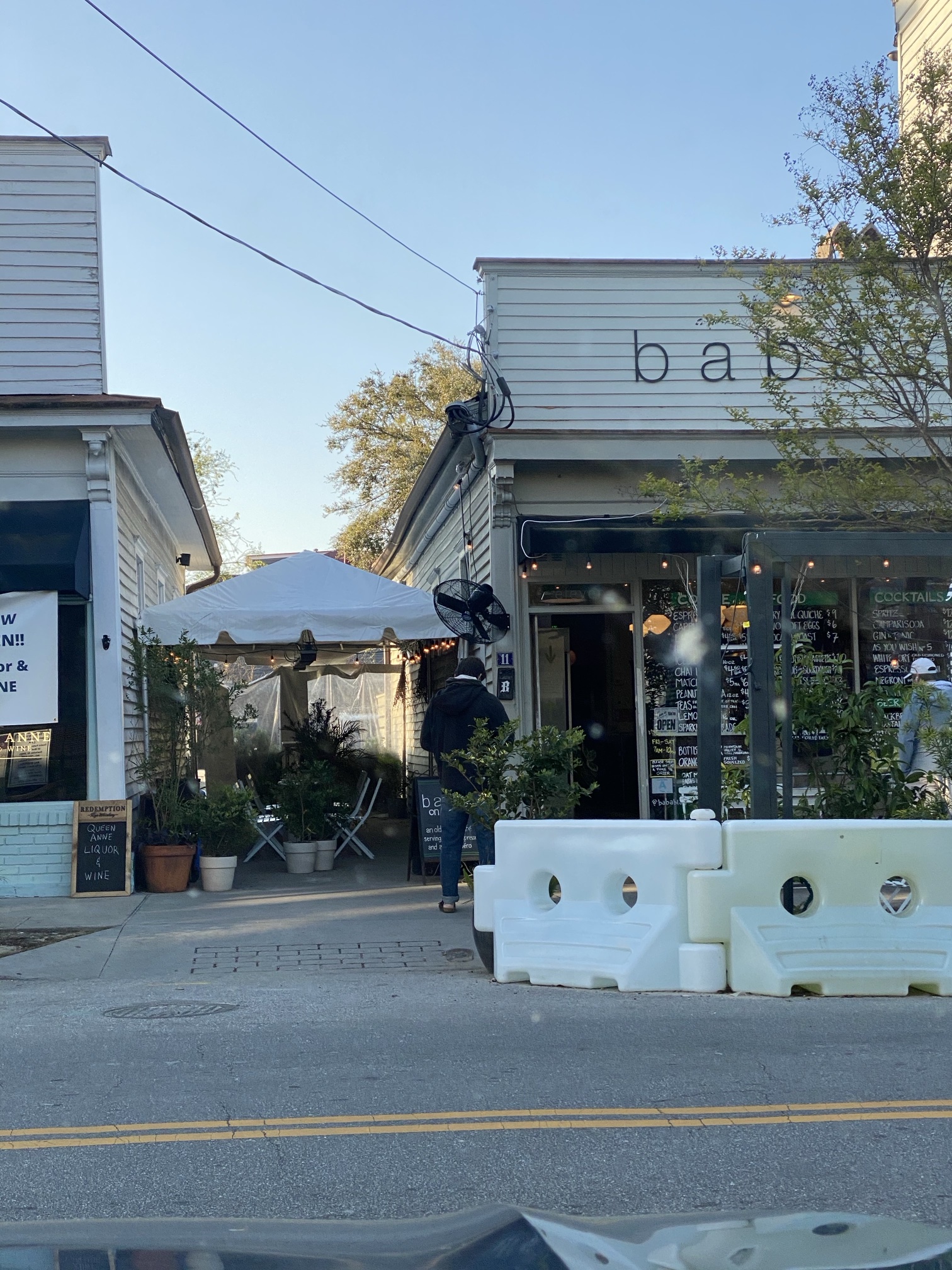 The front of Babas on Cannon, with chalkboard menus in the windows and a tented patio beside it