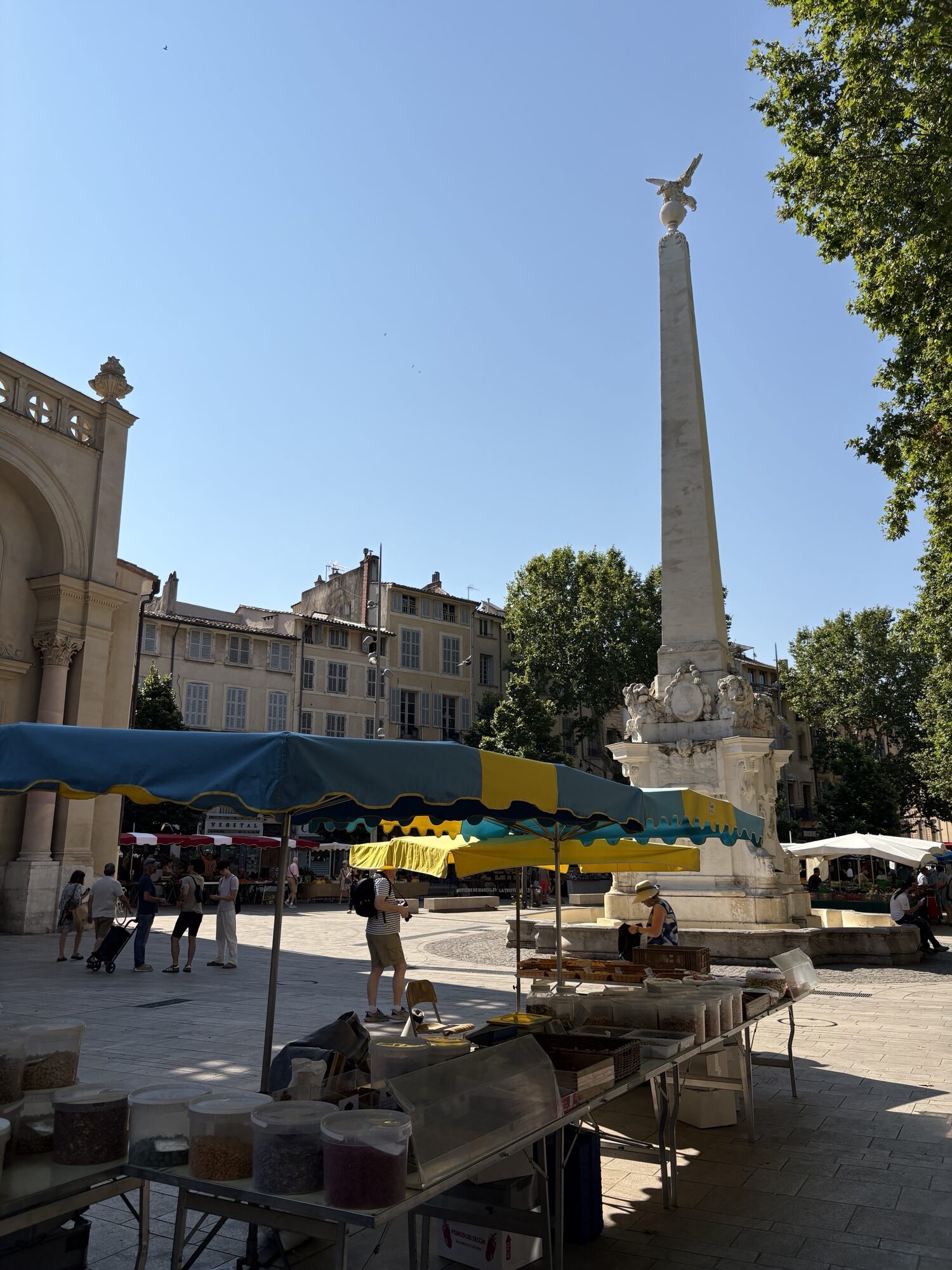 Market stalls around the obelisk fountain on Place des Prêcheurs in Aix-en-Provence